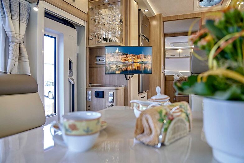 Vue depuis le cockpit sur la TV, l’armoire à verres et le réfrigérateur jusqu’à l’arrière.