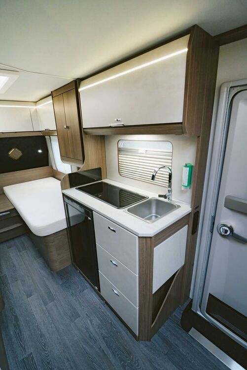 La cuisine compacte n’offre bien sûr qu’un plan de travail et un espace de rangement réduits mais dispose d’un équipement complet et séduit visuellement.