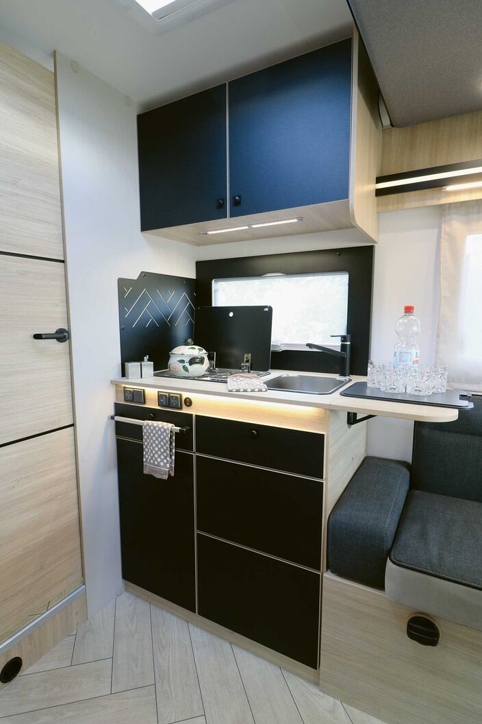 La cuisine compacte du Chausson 720 séduit par son équipement complet, ses nombreux éléments d’éclairage et ses rangements suffisants.